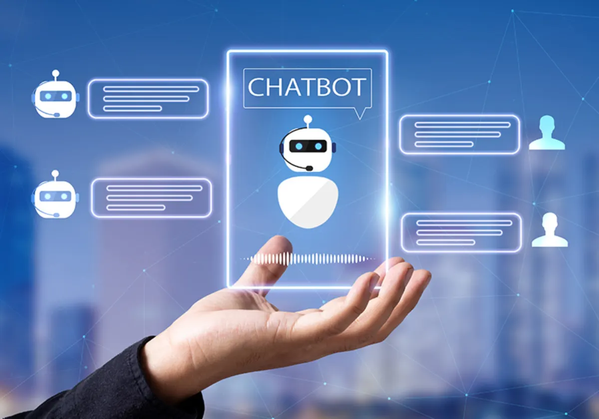 A hand holding a digital chat interface featuring a chatbot, conversation bubbles, and sound wave graphics against a blue background.