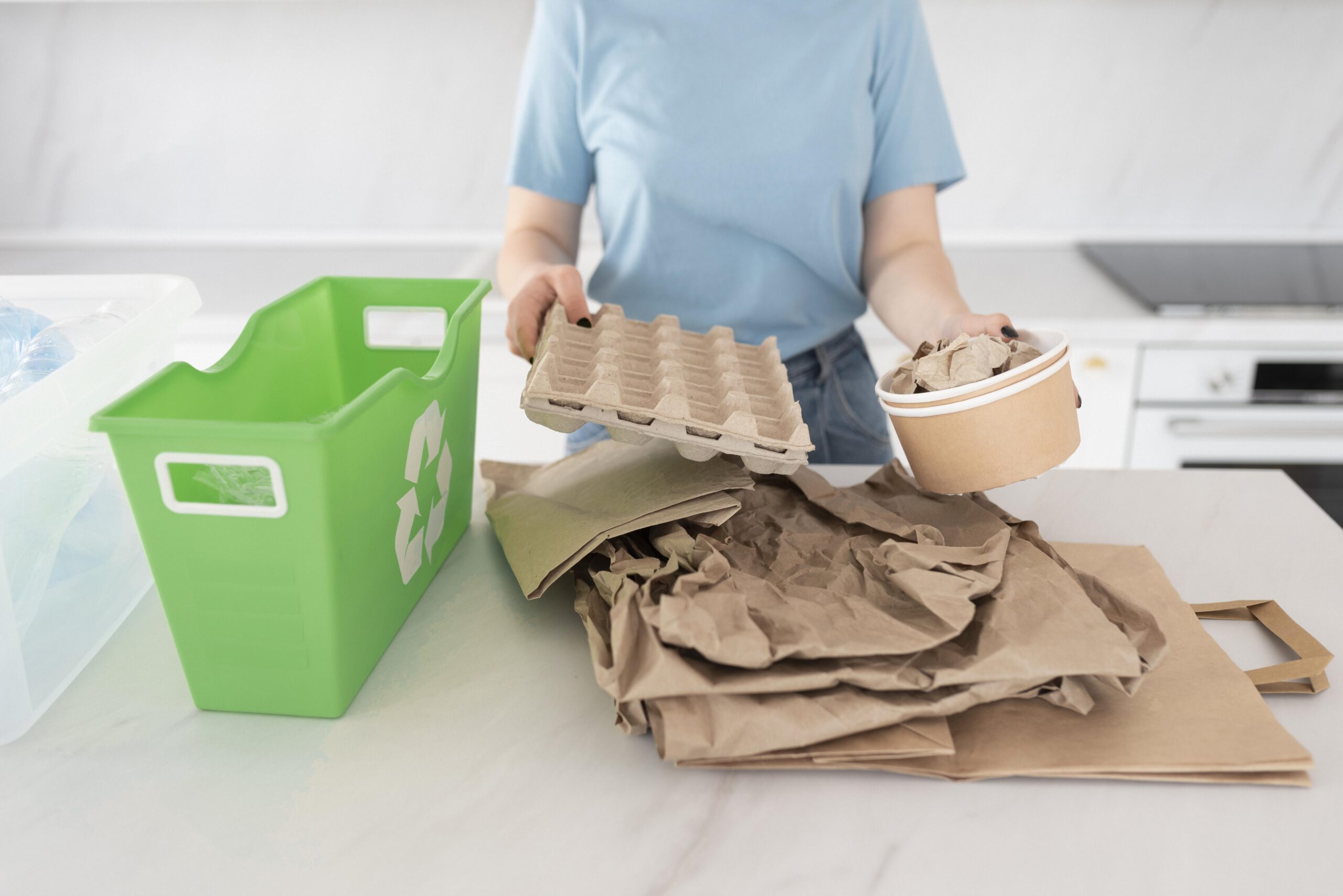 person holding a cardboard container and an egg carton