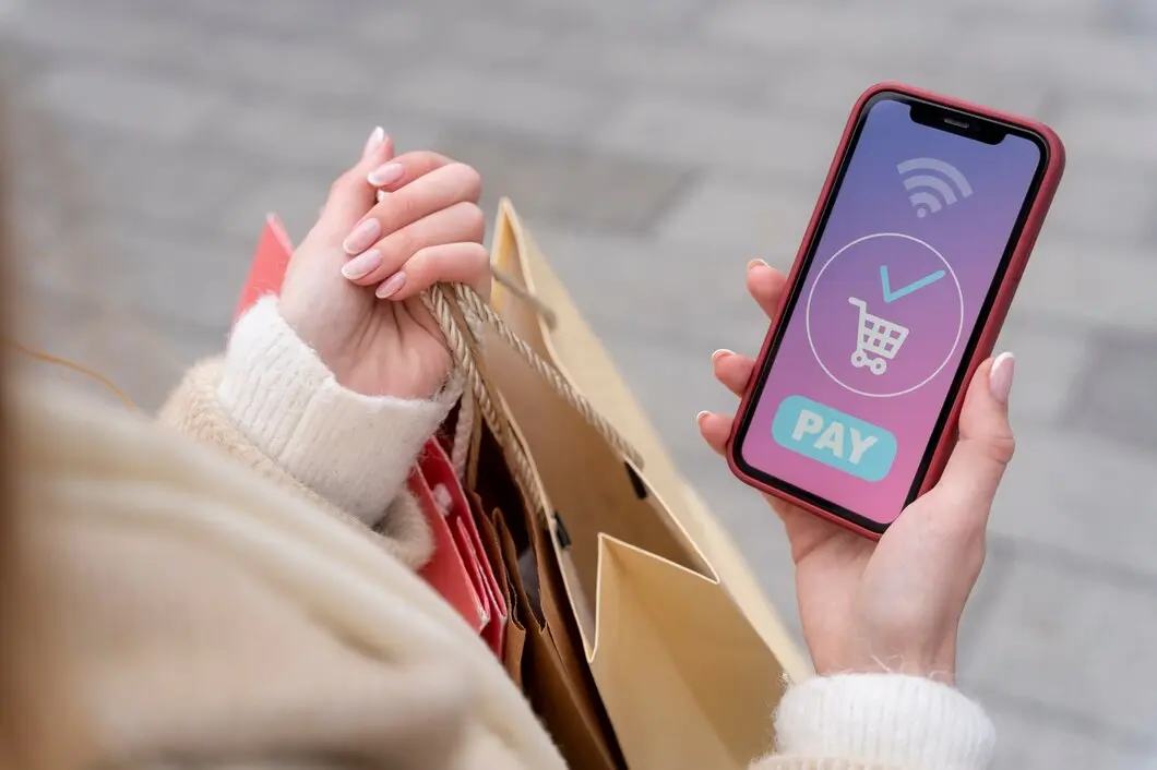 person holds a smartphone showing a successful online payment