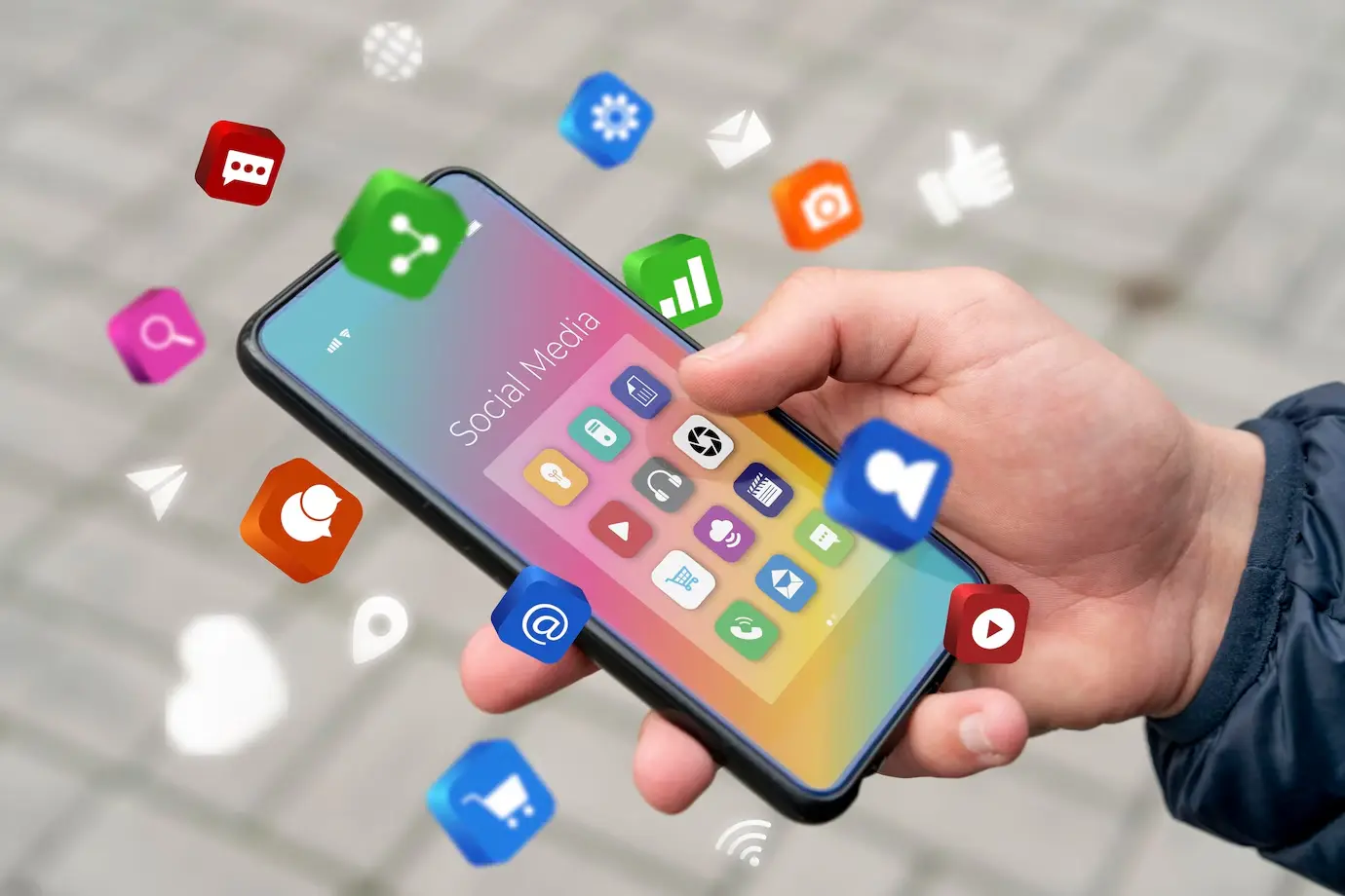 A person holds a smartphone displaying a colorful social media interface, surrounded by vivid app icons like chat, email, and video.